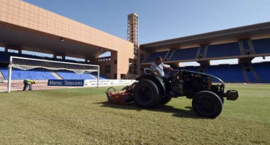 An employee cuts the grass on October 20, 2014 at the Marrakesh Stadium in the southern Moroccan city.  By Fadel Senna AFPFile