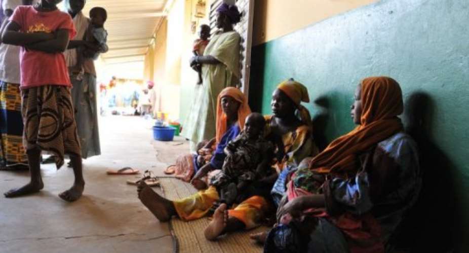 Mothers sit with their children suffering from malnutrition at the Gao hospital.  By Issouf Sanogo (AFP/File)