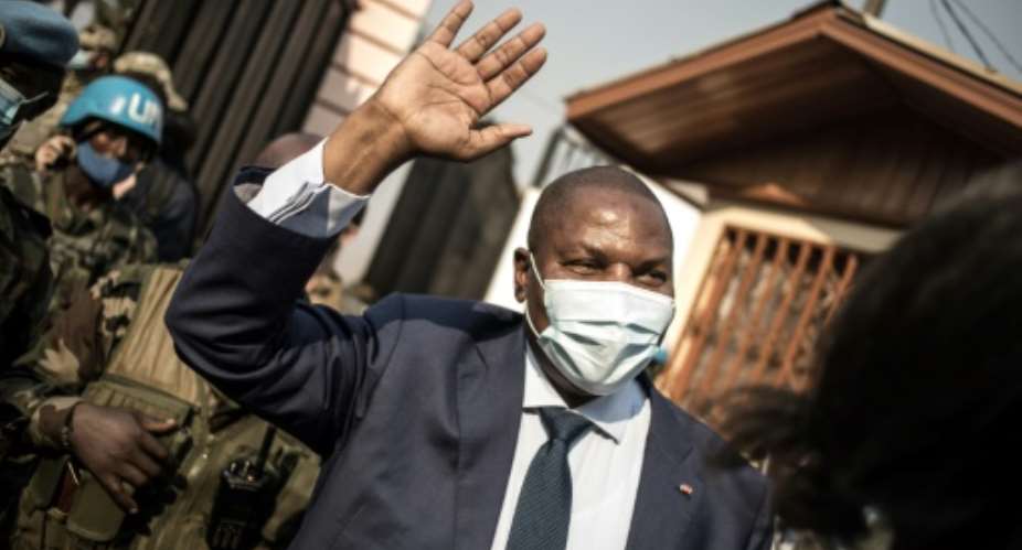 Re-elected: Touadera greets supporters outside his party headquarters in Bangui after his victory was confirmed by the Constitutional Court on Monday.  By FLORENT VERGNES AFP