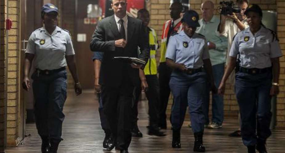 South African Paralympic athlete Oscar Pistorius C arrives to court on the third day of his sentencing in Pretoria on October 15, 2014.  By Ihsaan Haffejee PoolAFP