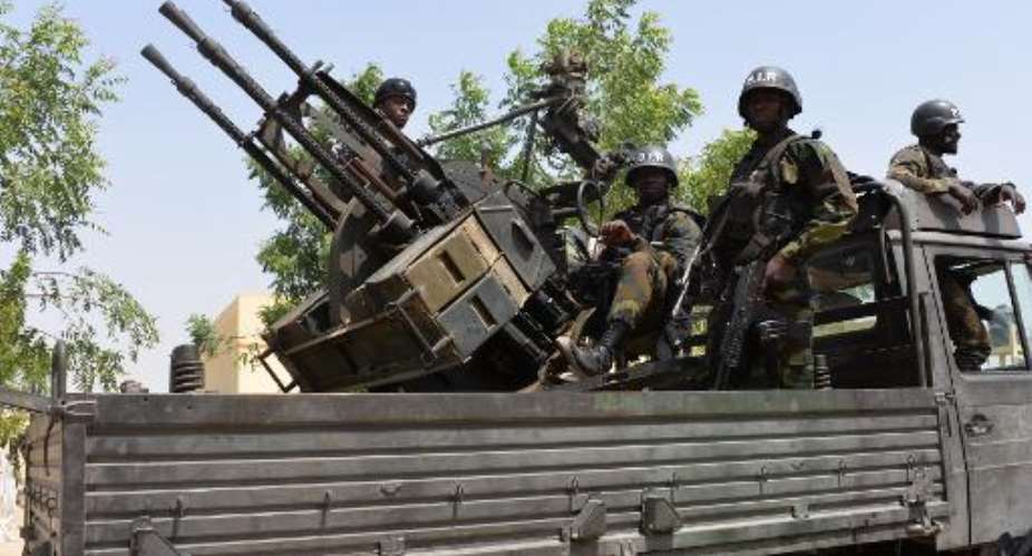 Cameroon soldiers patrol in city of Waza on February 17, 2015 as part of operations against Boko Haram.  By Reinnier Kaze AFP