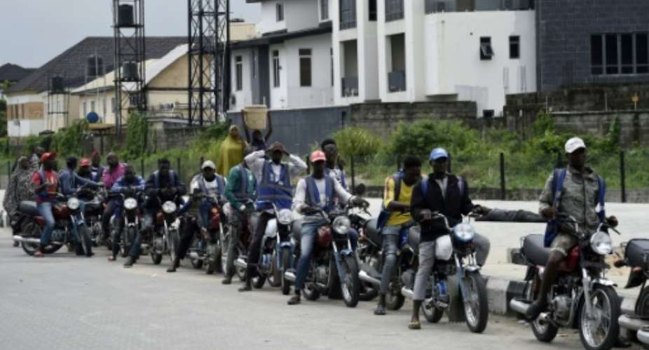 Regular motorcycle taxis involve rides without helmets for either driver or passenger.  By PIUS UTOMI EKPEI AFPFile