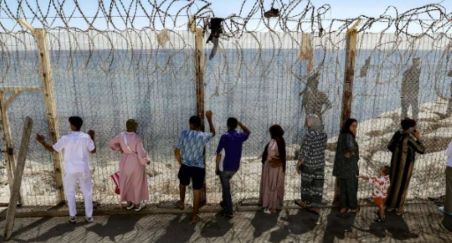 Relatives and friends wait at the border crossing for the return of people who crossed into Spains North African exclave of Ceuta,.  By Abdel Majid BZIOUAT (AFP)