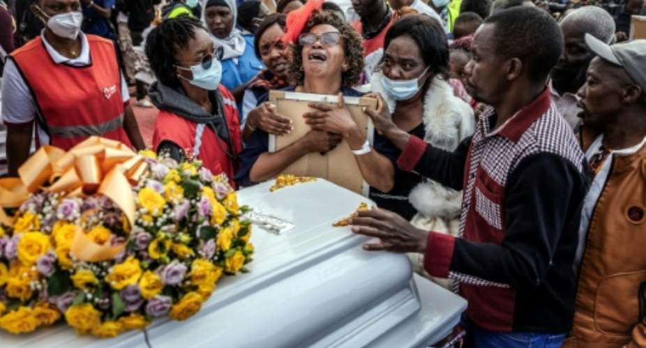 Relatives mourn at a memorial for victims of the Utumishi Girls Academy fire, the latest in a wave of such tragedies across Kenya.  By Luis TATO (AFP)