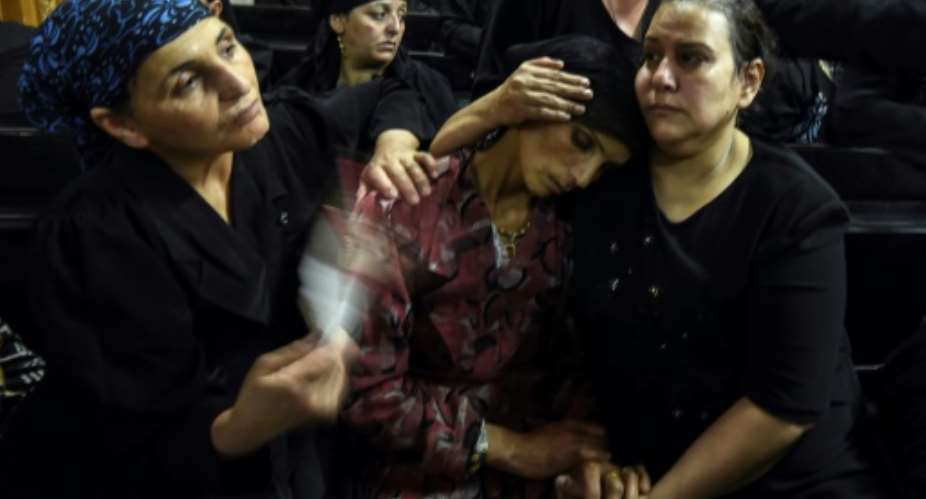 Relatives of killed Coptic Christians grieve during a funeral at Abu Garnous Cathedral in the north Minya town of Maghagha, on May 26, 2017.  By MOHAMED EL-SHAHED AFP