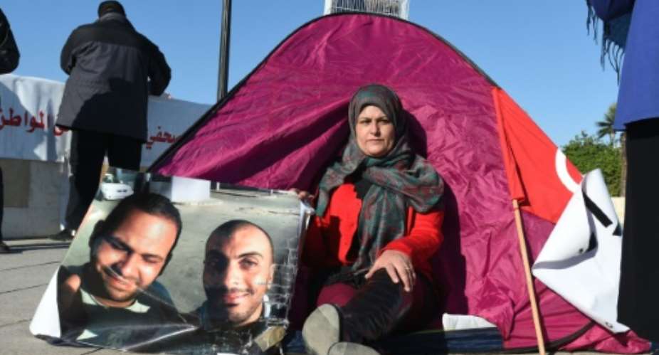 Sonia Rejab, the mother of Nadhir Ktari, a Tunisian photographer who went missing in eastern Libya in September 2014, stages a sit-in protest outside the Tunisian Prime Minister's offices on February 2, 2016 in Tunis.  By Fethi Belaid AFP