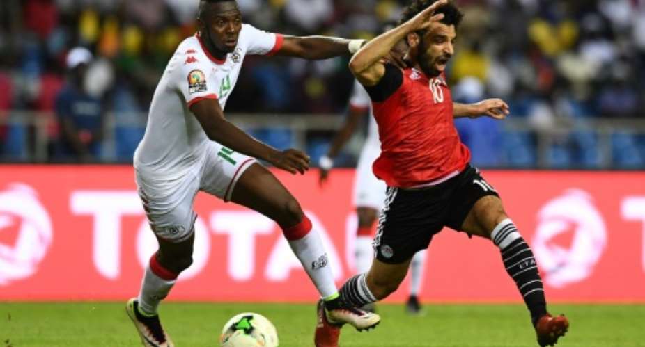 Renaissance Berkane defender Issoufou Dayo L challenges Mohamed Salah while playing for Burkina Faso against Egypt in a 2017 Africa Cup of Nations semi-final..  By GABRIEL BOUYS AFP