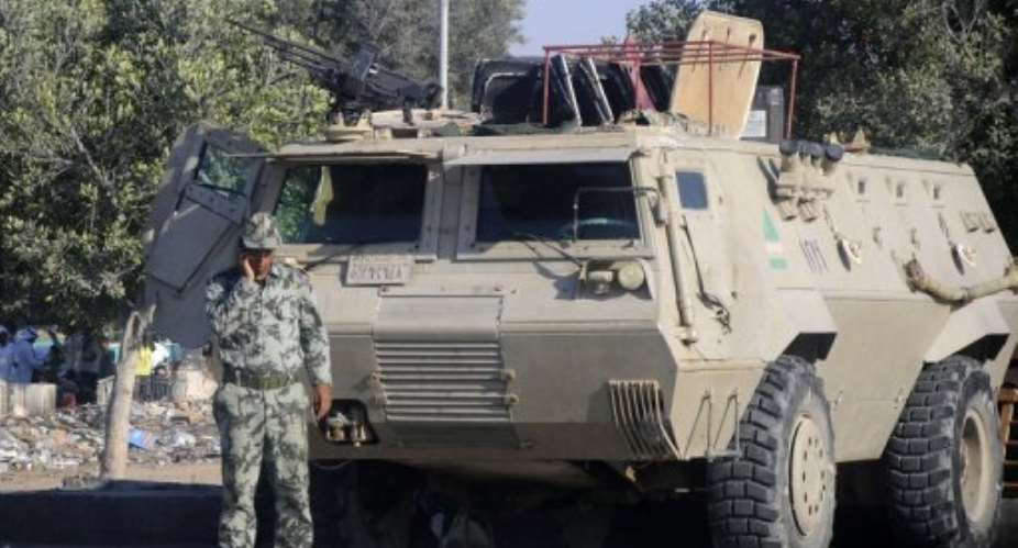 A member of the Egyptian security forces speaks on the phone while securing an area in El-Arish on the Sinai peninsula.  By - (AFP/File)