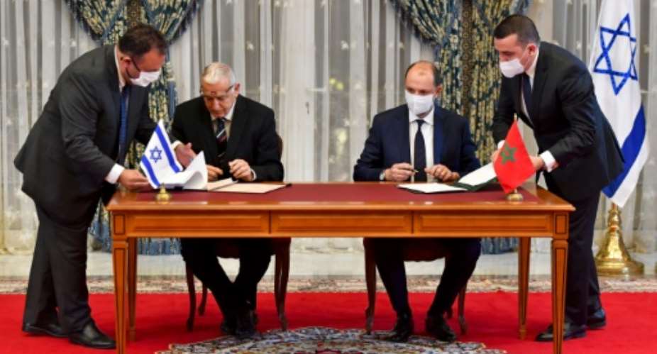 Representatives of Israel and Morocco sign landmark agreements at the Royal Palace in the Moroccan capital Rabat on December 22, 2020.  By FADEL SENNA AFP
