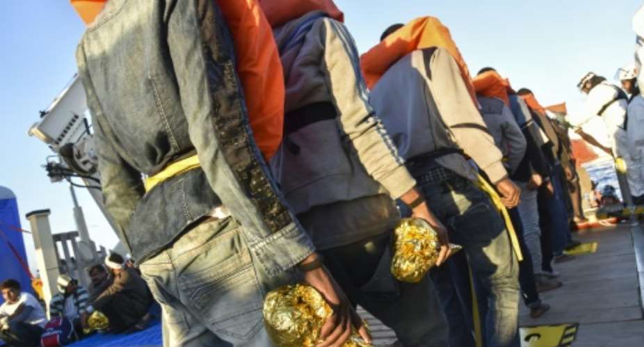 Rescued migrants and refugees wait to be transferred in 2016.  By ANDREAS SOLARO AFPFile