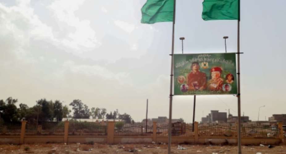 Resident of Libya's western town of Bani Walid still honour the dead dictator Moamer Kadhafi, with billboards of the strongman in his memory.  By Mahmud TURKIA AFP