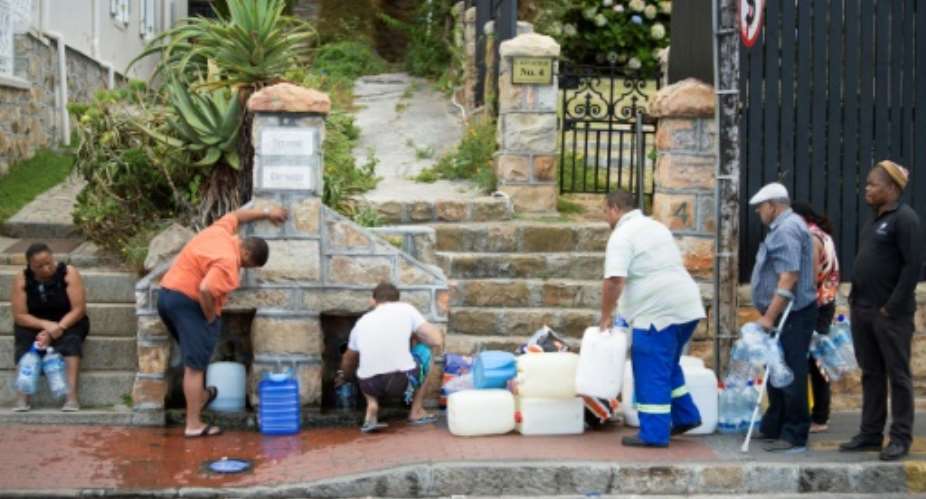 Residents from the Cape Town area collect drinking water from pipes, as a three-year-long drought grips the city.  By RODGER BOSCH AFPFile
