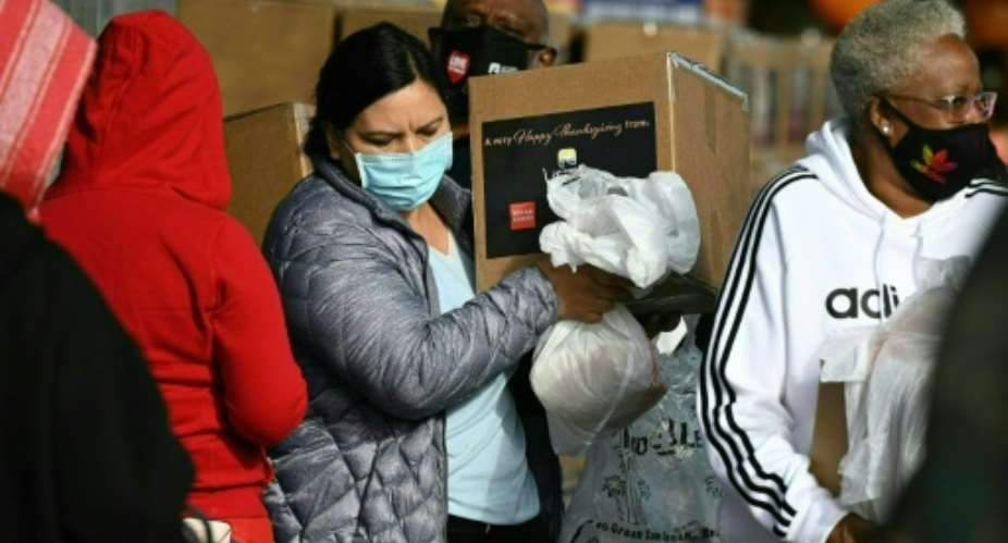 Residents hit financially by the pandemic receive Thanksgiving meal boxes at in Los Angeles, California, on November 20, 2020.  By Robyn Beck AFP