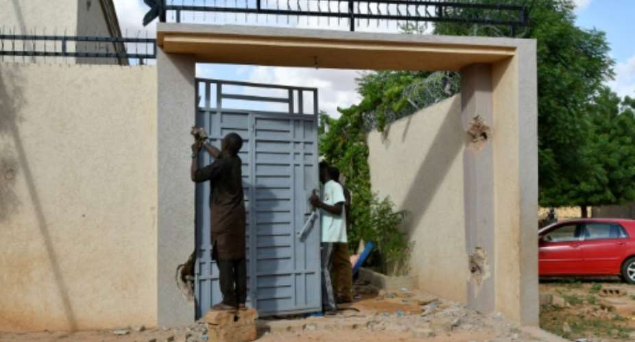 Residents of homes set for demolition in a green belt around Nigers capital remove elements of value before the bulldozers move in.  By BOUREIMA HAMA (AFP)