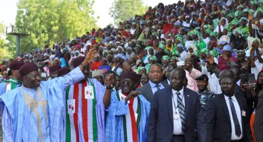 Nigerian President and presidential candidate of the ruling People's Democratic Party PDP Goodluck Jonathan L waves to supporters during a rally in Maiduguri on January 24, 2015.  By Tunji Omirin AFPFile