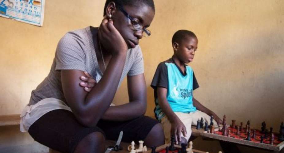 The 16-year old Phiona Mutesi L plays chess in Kampala on January 17, 2013.  By Michele Sibiloni AFP