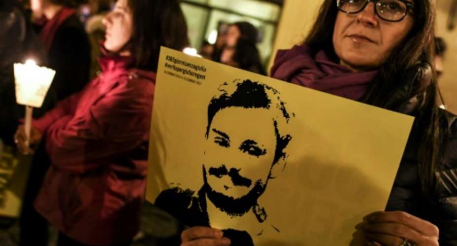 Rights activists hold up pictures of Giulio Regeni, an Italian student who was murdered in Egypt, at a protest in Rome on January 25, 2017.  By Andreas SOLARO AFPFile
