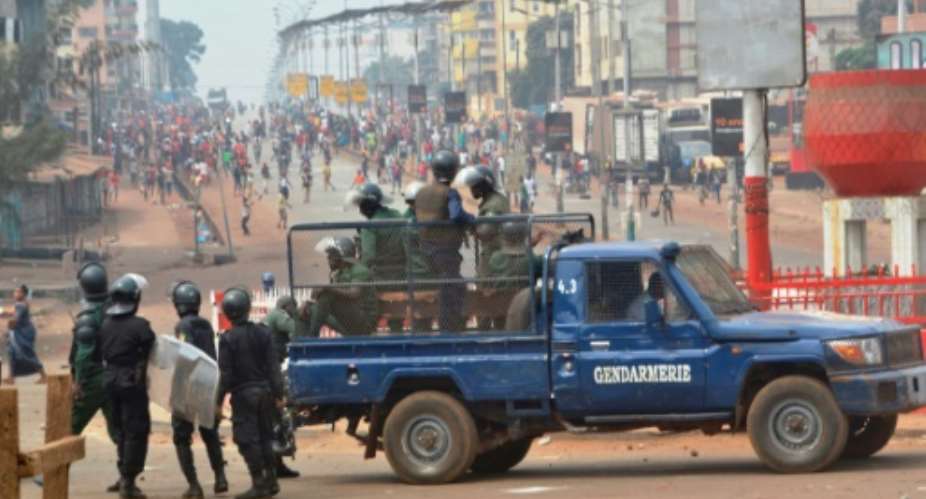 Riot police get ready to disperse people demonstrating to denounce the results of the local elections, on February 6, 2018 in Conakry.  By CELLOU BINANI AFPFile