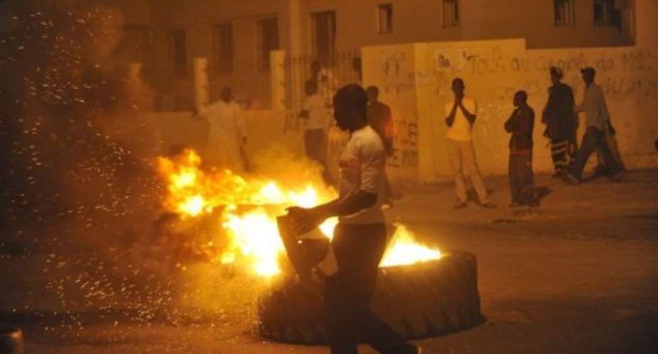 Violence spread through Dakar as rioters engaged in running battles with police, setting alight tyres and shops.  By Toure Behan (AFP)