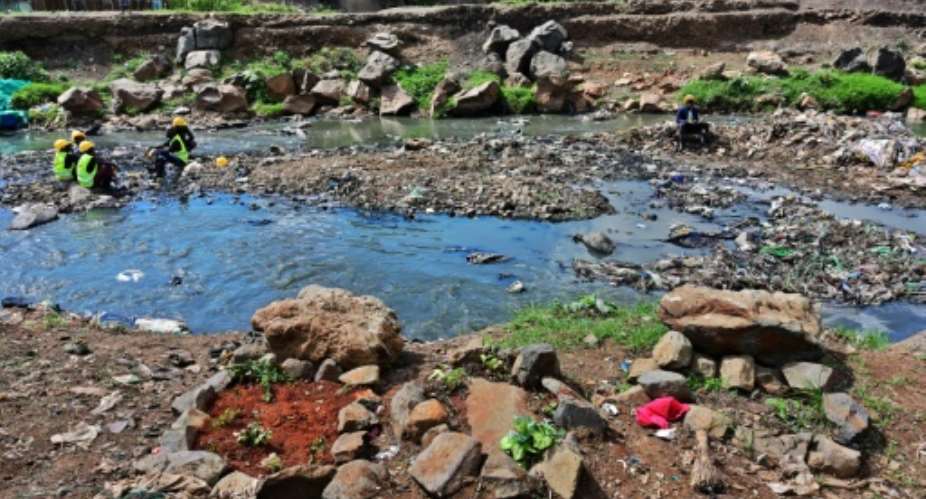 Rock arrangements mark the ground where authorities say bodies, mostly babies, were recovered from Nairobi's rivers.  By TONY KARUMBA AFP