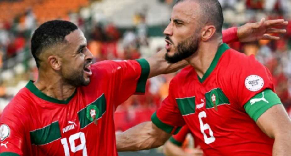 Romain Saiss R celebrates scoring for Morocco with Youssef En-Nesyri.  By SIA KAMBOU AFP