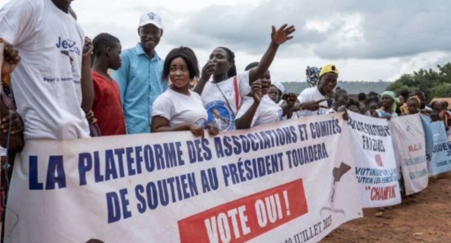 Ruling party supporters in Bangui with a banner urging people to vote yes for the upcoming referendum.  By Barbara DEBOUT AFP
