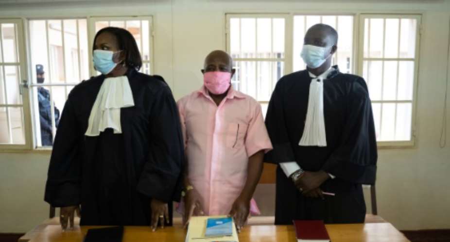 Rusesabagina, centre, seen in prison uniform at his court appearance in Kigali last October.  By Simon Wohlfahrt AFP
