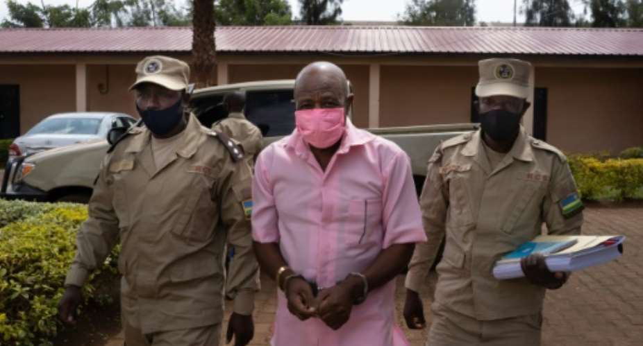 Rusesabagina in pink prison uniform, arriving at the Nyarugenge Court of Justice in Kigali last October.  By Simon Wohlfahrt AFPFile