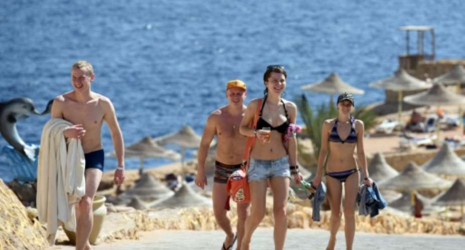 Tourists pictured returning from the beach in the Egyptian resort of Sharm el-Sheikh on November 7, 2015.  By Mohamed El-Shahed AFP