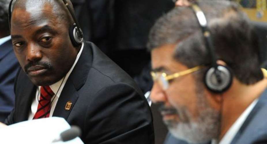 Democratic Republic of Congo's President Joseph Kabila L looks at Egypt's newly-elected president Mohamed Morsi.  By Simon Maina AFP