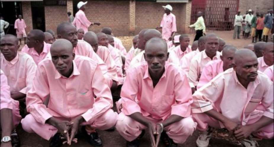 Prisoners in pink uniforms wait inside the prison of Gitarama to be transferred and attend a gacaca court session.  By Thomas Lohnes AFPDDPFile