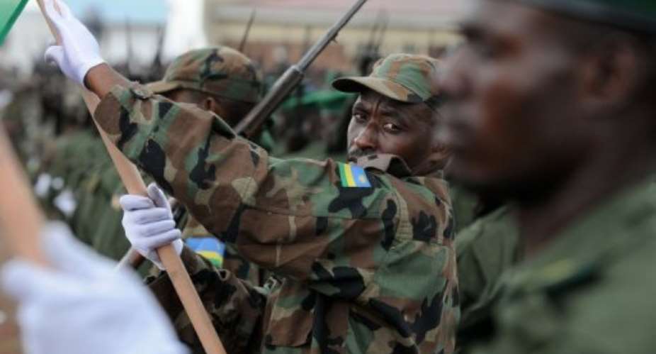 A Rwandan soldier looks at a Congolese colleague in 2009 in Goma.  By Lionel Healing (AFP/File)