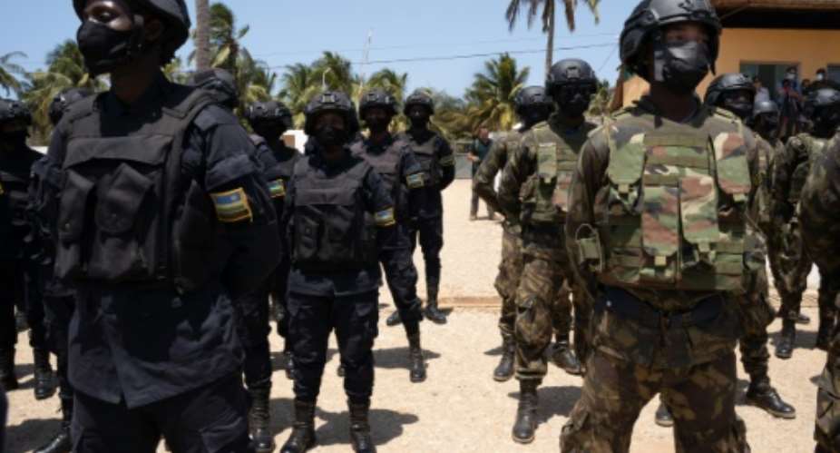Rwandan police (left) pictured alongside Mozambican troops in 2021.  By Simon WOHLFAHRT (AFP/File)