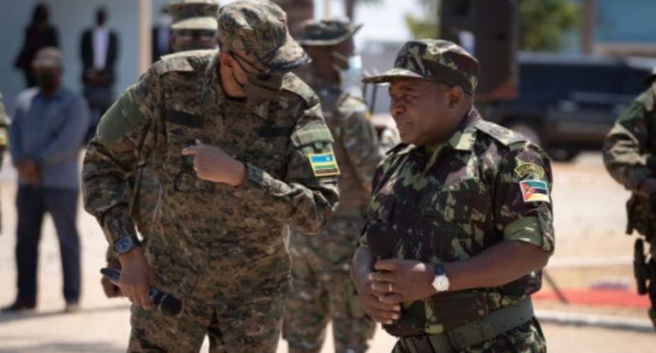 Rwandan President Paul Kagame, left, and Mozambican President Filipe Nyusi, clad in military fatigues, reviewed troops in Pemba.  By Simon WOHLFAHRT AFP