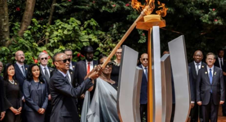 Rwandan President Paul Kagame lights a remembrance flame on the 30th anniversary of the genocide.  By LUIS TATO AFP