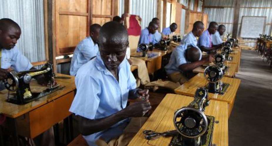 Rwandan youths take part in a tailoring course at a rehabilitation and skills development centre on the island of Iwawa, on May 8, 2014.  By Stephanie Aglietti (AFP)