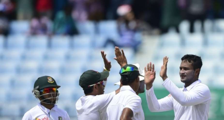 Bangladesh spinner Shakib Al Hasan R celebrates with teammates the dismissal of South Africa batsman Faf du Plessis on the first day of the first Test in Chittagong on July 21, 2015.  By Munir Uz Zaman AFP