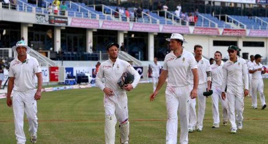 Jacques Kallis, wicketkeeper AB de Villiers and captain Graeme Smith of South Africa walk out of the grounds with their team after winning the second test cricket match against Pakistan in Dubai on October 26, 2013.  By Marwan Naamani AFPFile
