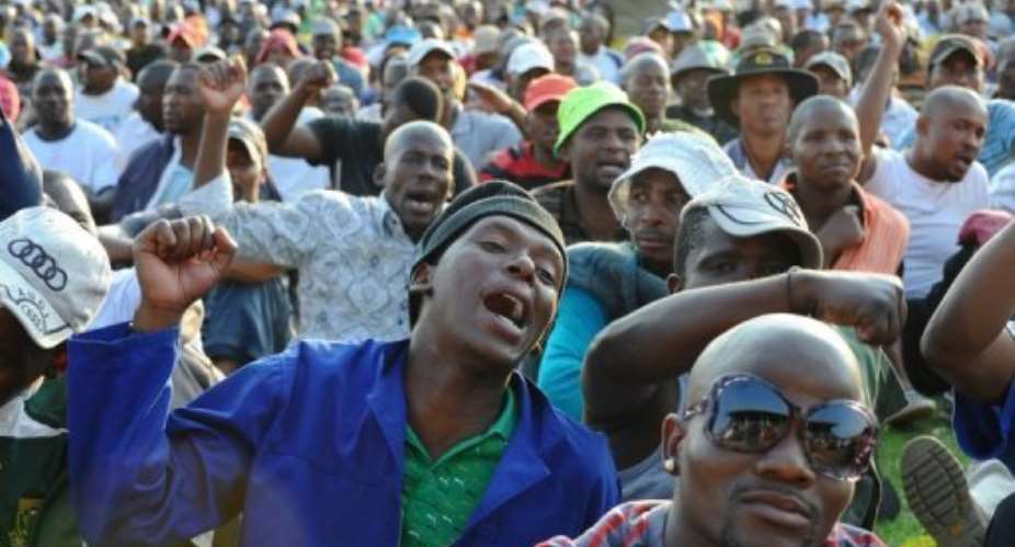 Striking miners gesture and chant as they celebrate after securing a 22 percent pay hike.  By Alexander Joe (AFP)