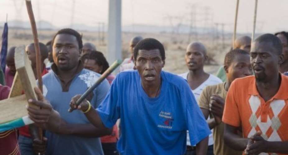 Striking Lonmin mine workers sing and dance in Marikana on August 29, 2012.  By Rodger Bosch (AFP/File)