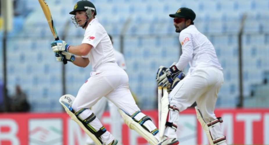 South Africa batsman Stiaan van Zyl L plays a shot as the Bangladesh wicketkeeper Litton Das looks on during the third day of the first Test in Chittagong on July 23, 2015.  By Munir Uz Zaman AFP
