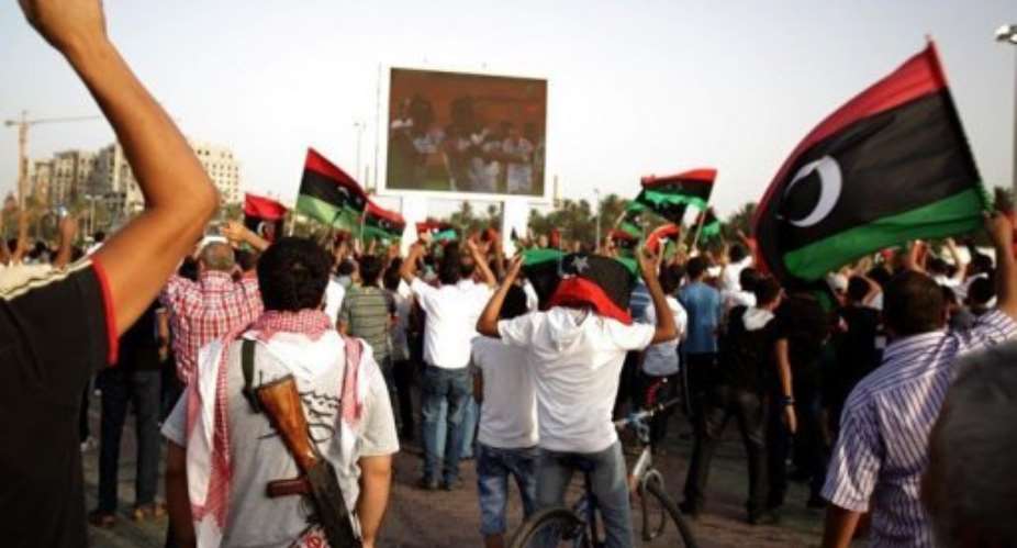 Libyans celebrate a goal as they watch the Africa Cup of Nations football qualifying match between Libya and Mozambique.  By Patrick Baz (AFP/File)