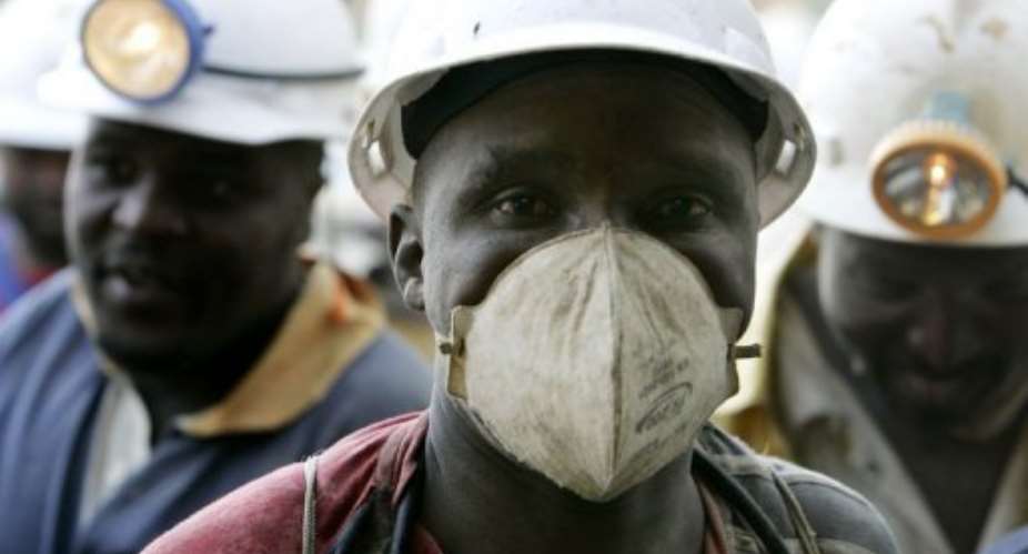 South African miners show relief on their faces as their come out of a lift after being stuck for hours in a gold mine.  By Gianluigi Guercia (AFP/File)