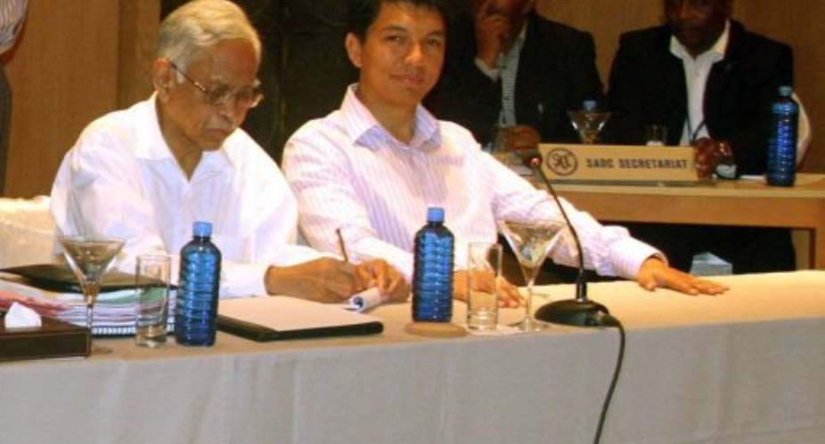 Madagascar President Andry Rajoelina (2nd L) attends a session of Southern African Development Community-mediated talks.  By  (AFP/SEYCHELLES PRESIDENTIAL OFFICE/File)