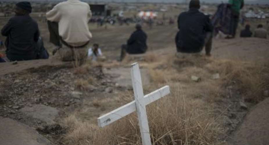 People gather on August 16, 2014 in Marikana next to the hill where, two years ago, miners where gunned down by South African police during a violent wave of strikes.  By Mujahid Safodien AFPFile