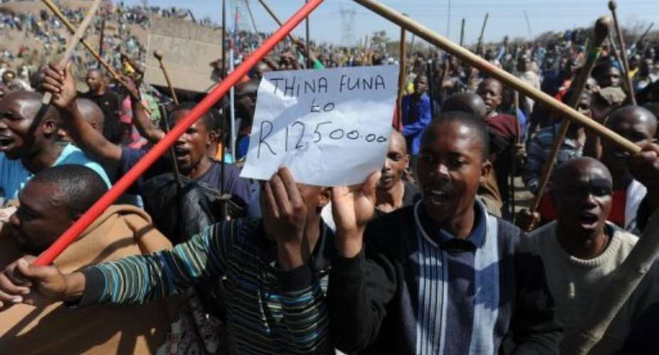 Miners demonstrate near Rustenberg on August 16.  By - AFP