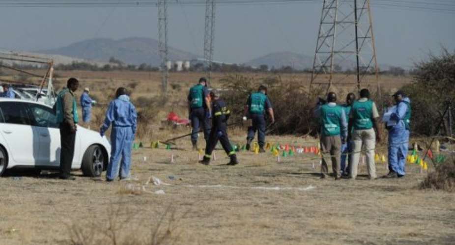Police forensic experts work at the scene of the shooting.  By  (AFP)