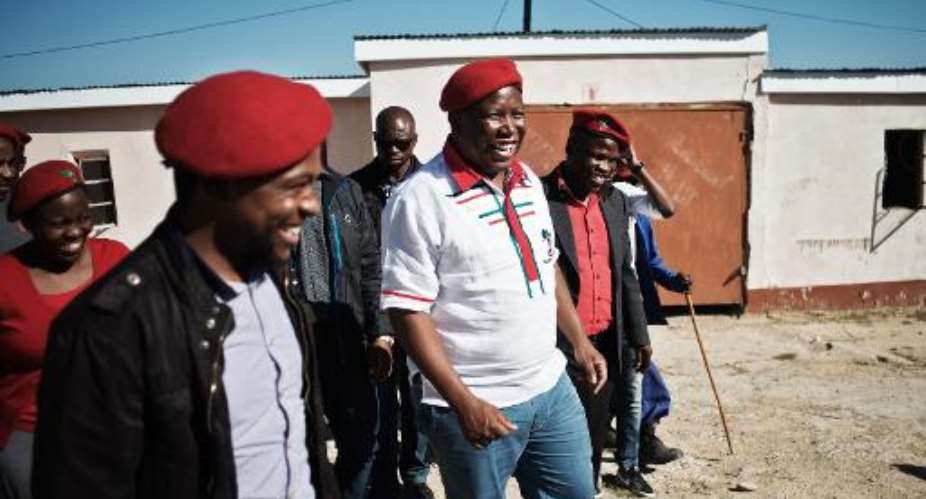 Economic Freedom Fighters president Julius Malema C greets the local community in Ngcingwane, during a pre-campaign tour in the Eastern Cape province of South Africa, on April 11, 2014.  By Gianluigi Guercia AFPFile