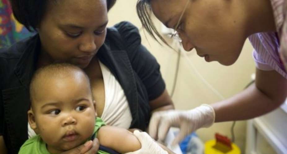 A nurse injects a child with a new TB vaccine on January 27, 2011, in Worcester, South Africa.  By Rodger Bosch AFPFile