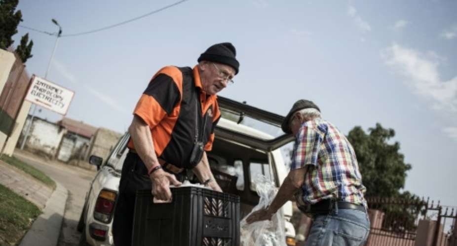 Adriaan Vlok, former South African apartheid law and order minister who oversaw a brutal police crackdown, delivers free food around a township as he seeks to atone for his sins.  By John Wessels AFP